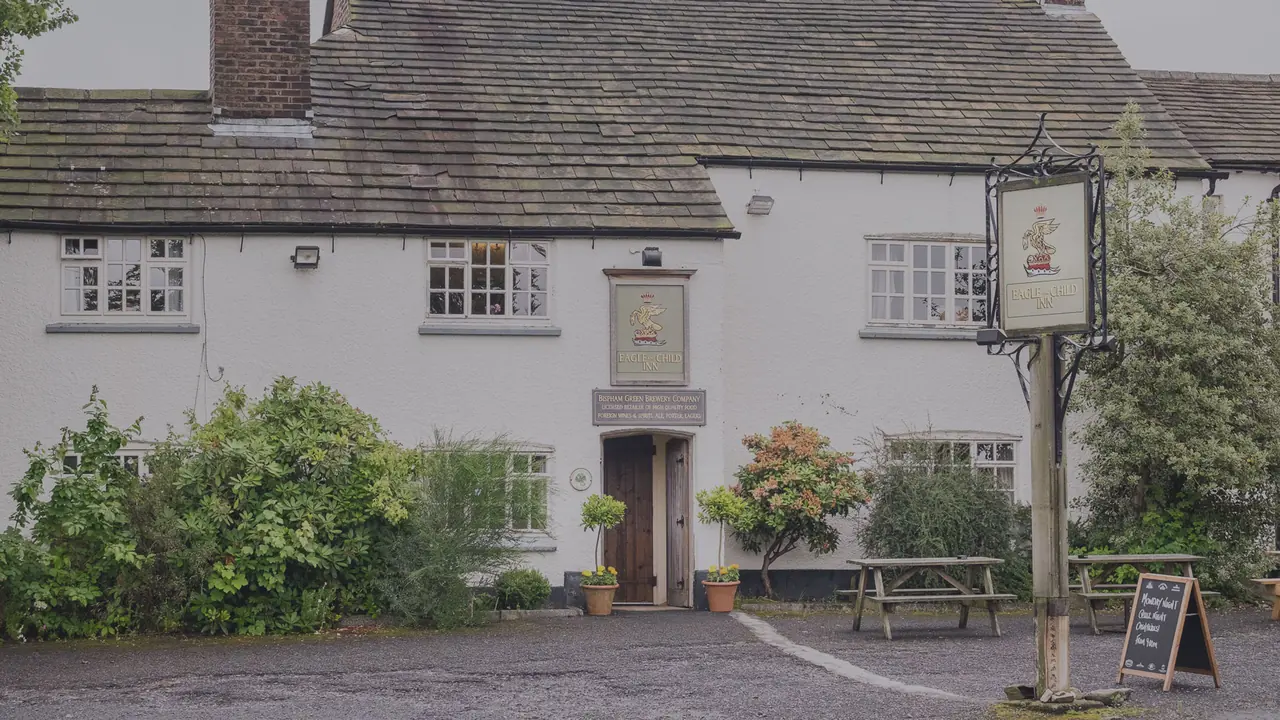 The Eagle and Child, a white-washed country pub on the village green at Bispham Green